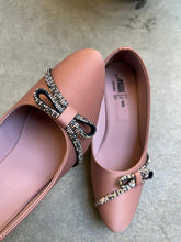 Load image into Gallery viewer, Pair of pink flats with decorative straps on a concrete floor.
