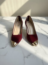 Load image into Gallery viewer, Pair of maroon high heels with gold tips on a gray surface
