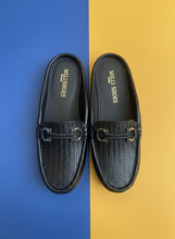 Load image into Gallery viewer, Pair of black loafers with a brand logo on a gray surface
