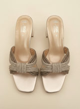 Load image into Gallery viewer, Pair of gold embellished sandals on a dark background
