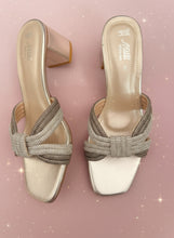 Load image into Gallery viewer, Pair of high-heeled shoes with decorative straps on a dark background
