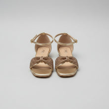 Load image into Gallery viewer, Gold high-heeled sandals with decorative bows on a gray surface
