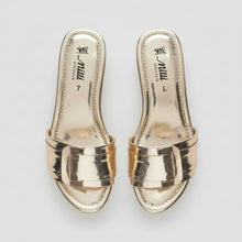 Load image into Gallery viewer, A pair of metallic silver slide sandals, shown from both the top and side views, resting on a gray textured floor. The brand name 'miu miu' is visible on the insoles.
