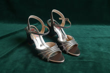 Load image into Gallery viewer, Pair of high-heeled sandals with metallic strap design on a gray surface
