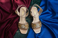 Load image into Gallery viewer, Pair of high-heeled sandals with decorative straps on a gray surface
