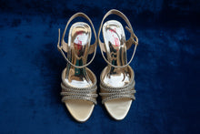 Load image into Gallery viewer, Silver high-heeled shoes with embellishments on a reflective surface
