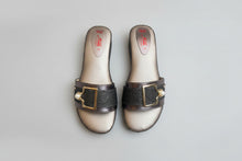 Load image into Gallery viewer, Pair of silver sandals with brown straps featuring a gold buckle on a light gray background.

