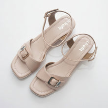 Load image into Gallery viewer, Pair of beige sandals with thin straps on a gray surface

