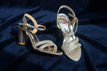Load image into Gallery viewer, Silver high-heeled sandals with 'Mia' branding on a concrete surface
