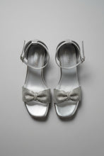 Load image into Gallery viewer, Silver high-heeled sandals with rhinestone embellishments on a textured surface
