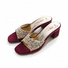 Load image into Gallery viewer, Maroon high-heeled shoes with multicolored embellishments on a gray marble surface
