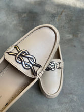 Load image into Gallery viewer, Beige loafer with decorative emblem on a gray surface
