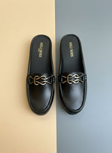Load image into Gallery viewer, Pair of black loafers with gold accents on a gray surface
