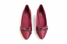 Load image into Gallery viewer, Red shoe with decorative bow on a textured surface
