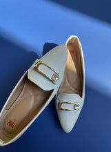 Load image into Gallery viewer, White shoes with decorative metal buckles on a neutral background
