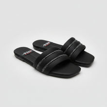 Load image into Gallery viewer, Black sandals with white sole on a gray tiled floor
