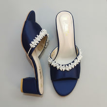Load image into Gallery viewer, Navy blue sandals with pearl embellishments on a gray surface
