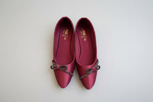 Load image into Gallery viewer, Pair of red shoes with decorative straps on a concrete floor
