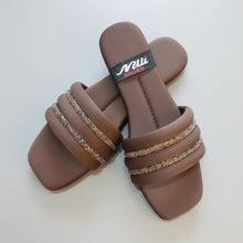Load image into Gallery viewer, Brown sandals with decorative straps on a gray surface
