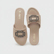 Load image into Gallery viewer, A pair of beige slide sandals with large rectangular buckle embellishments, one in black rhinestones and the other in silver rhinestones, displayed on a gray textured surface.
