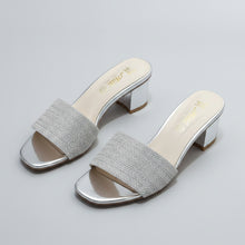Load image into Gallery viewer, Silver high-heeled shoes with rhinestone embellishments on a gray marble surface
