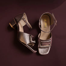 Load image into Gallery viewer, Pair of metallic high-heeled shoes on a textured surface
